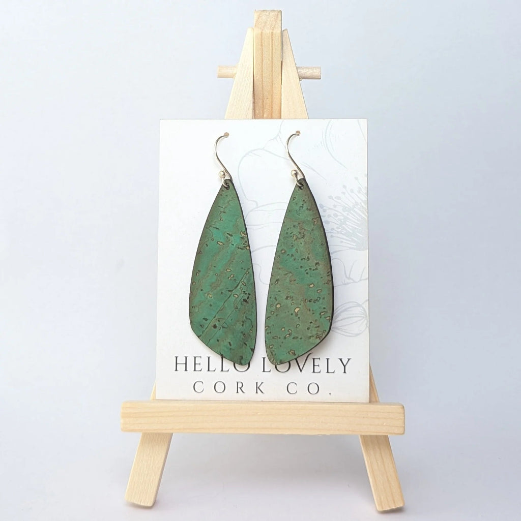 Green cork earrings on a 'Hello Lovely Cork Co.' card with a wooden stand against a white background