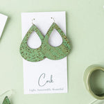 Green cork earrings on a white card with 'Cork' text, against a light green background.