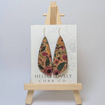 A pair of floral cork earrings displayed on a small wooden easel with the brand name 'Hello Lovely Cork Co.'