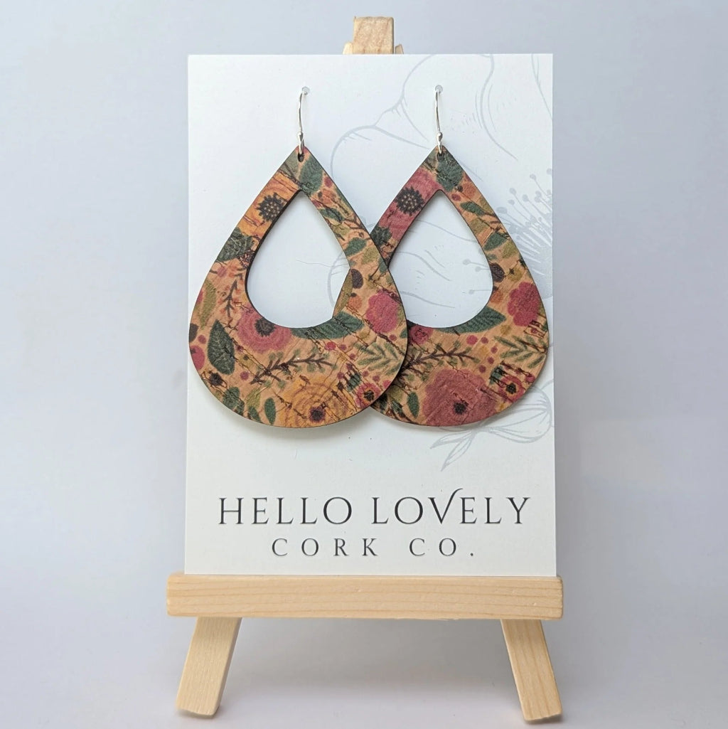 Floral patterned cork earrings on a 'Hello Lovely Cork Co.' card with a wooden stand.