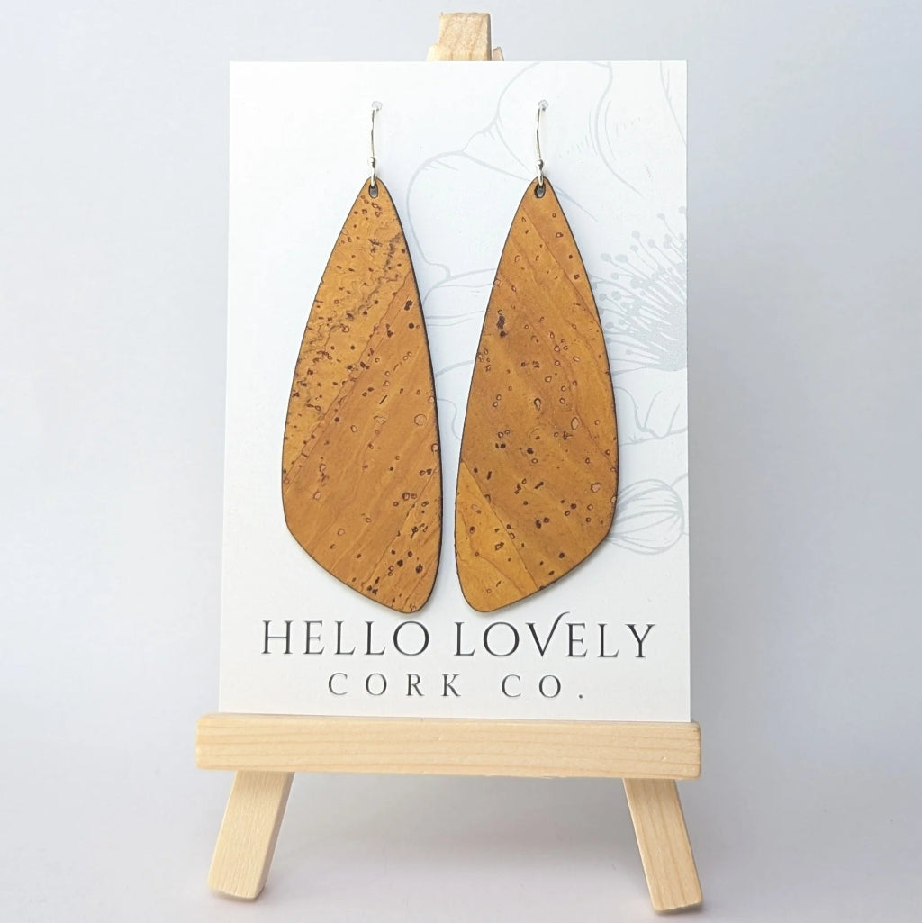 Cork earrings on a 'Hello Lovely Cork Co.' card with a wooden stand against a light gray background